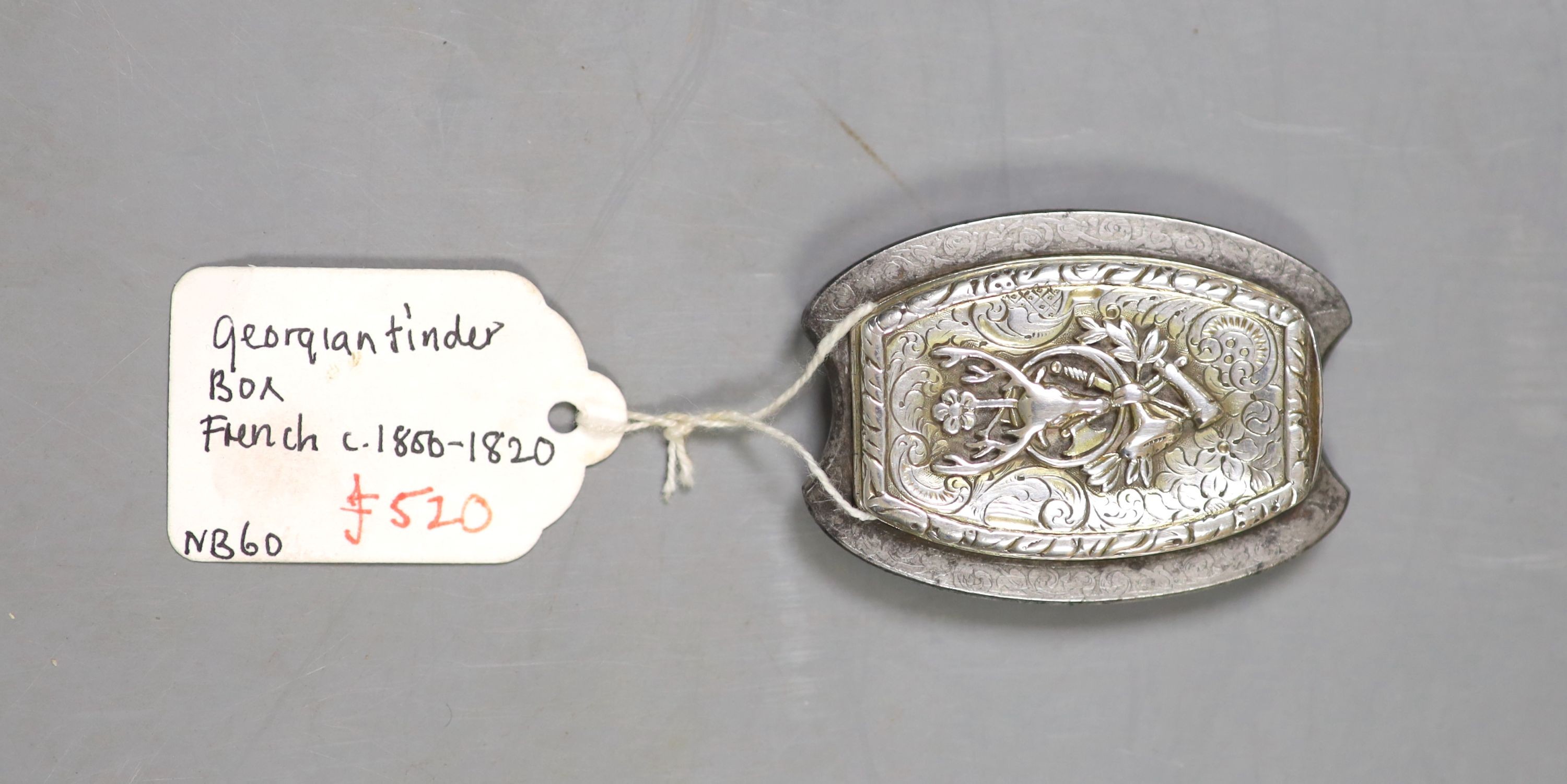 A 19th century French gilt white metal and steel shaped oval tinder box, with stag's head and foliate decoration, 52mm.